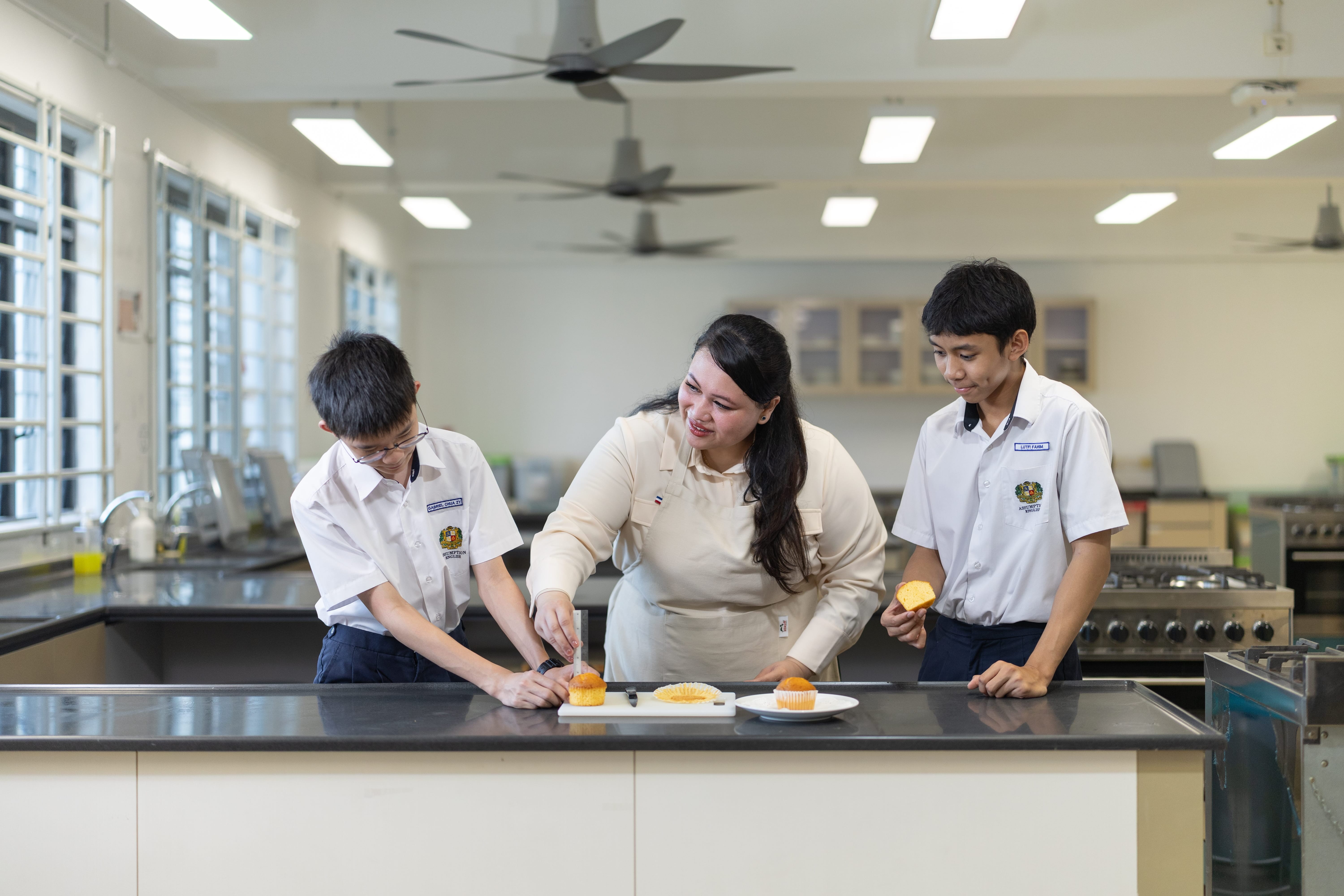 Teacher teaching students how to bake pastries.